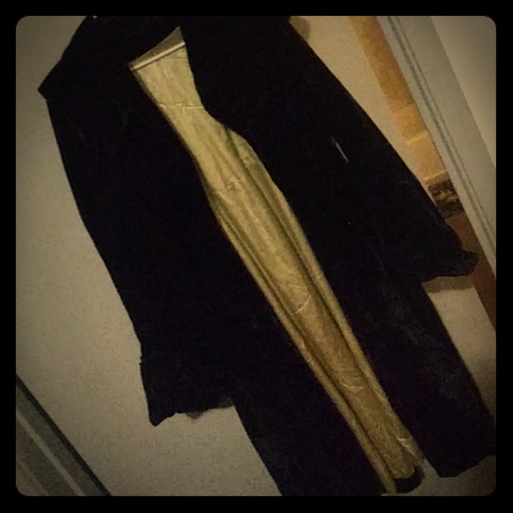 A black long faux fur looking jacket that hits th